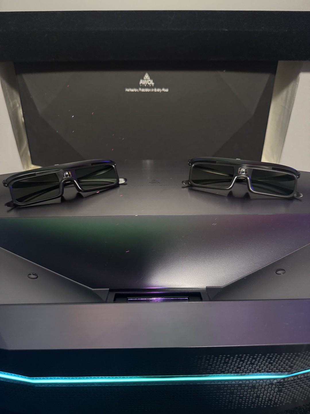 Two pairs of active DLP-Link 3D glasses on the Aetherion Max chassis